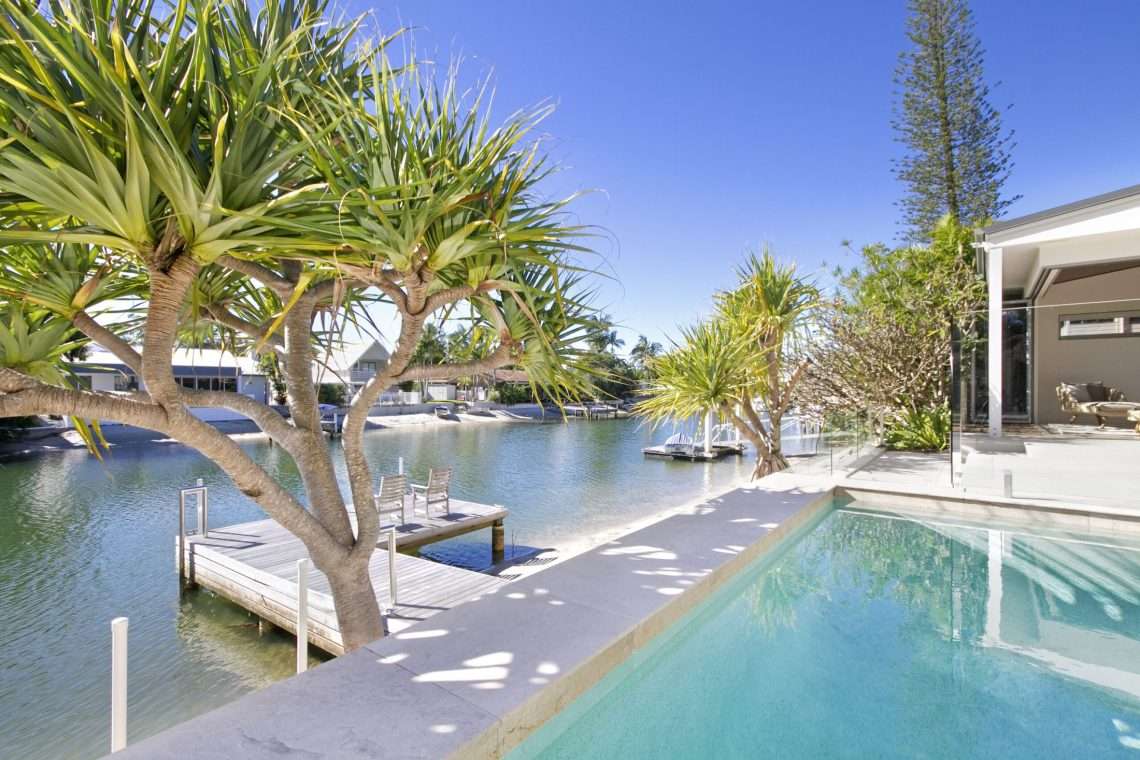 Waterfront Noosa home with pool, jetty and pandanus trees